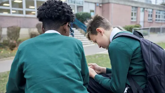 Two teenage boys sat outside.