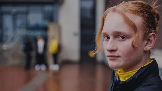 A teenage girl looking thoughtful