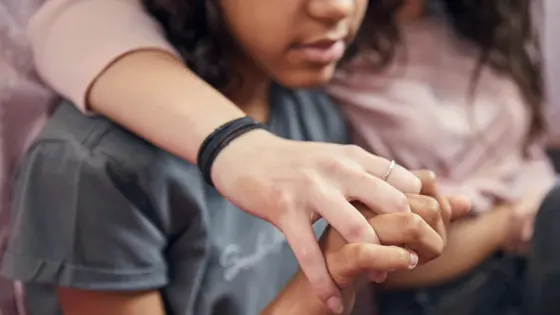 Photo of a couple sitting together holding hands.